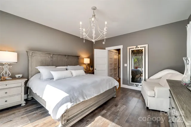 a living room with a bed furniture and a flat screen tv