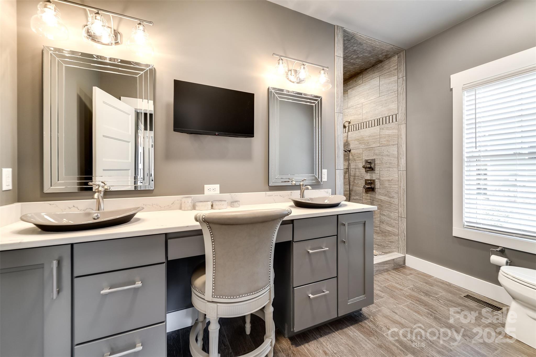 117 Amberleaf Way Cullowhee, NC 28723 - Photo 23 of 47 a bathroom with a double vanity sink a mirror and a toilet