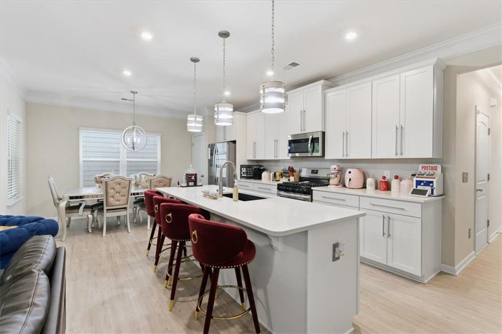 140 Bryon Lane Acworth, GA 30102 - Photo 12 of 39 a kitchen with stainless steel appliances kitchen island a table chairs and a refrigerator