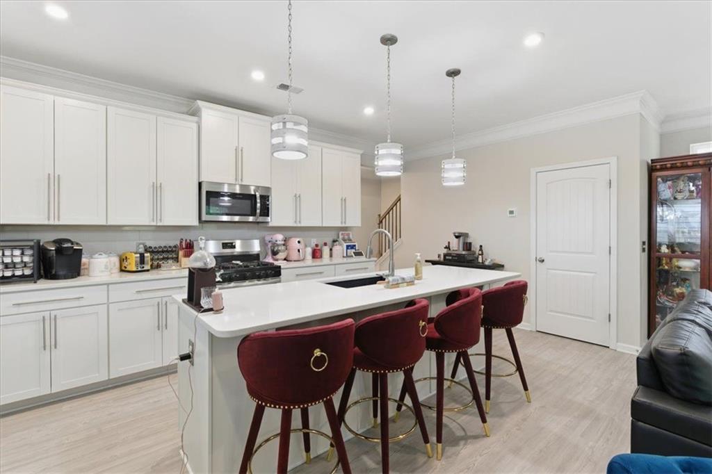 140 Bryon Lane Acworth, GA 30102 - Photo 13 of 39 a kitchen with stainless steel appliances kitchen island granite countertop a sink a stove a dining table and chairs