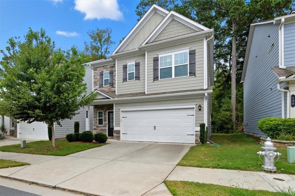 140 Bryon Lane Acworth, GA 30102 - Photo 2 of 39 a front view of a house with a yard and garage