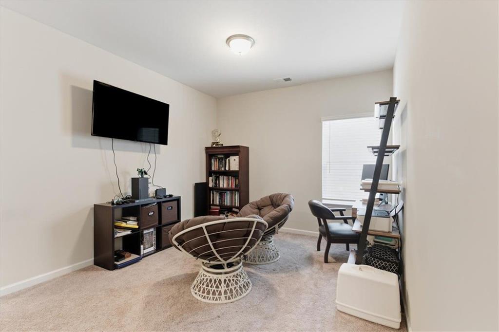 140 Bryon Lane Acworth, GA 30102 - Photo 25 of 39 a work room with furniture and a flat screen tv