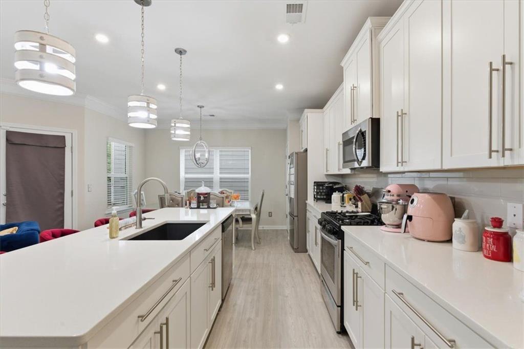 140 Bryon Lane Acworth, GA 30102 - Photo 9 of 39 a kitchen with kitchen island granite countertop a sink a stove oven a counter space and cabinets