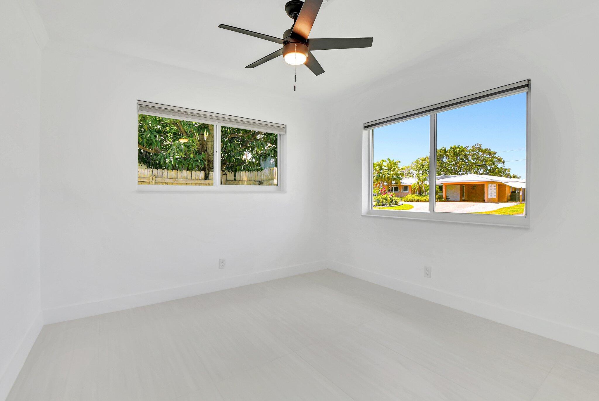 832 Southwest 10th Avenue Boca Raton, FL 33486 - Photo 27 of 57 an empty room with a window and a ceiling fan