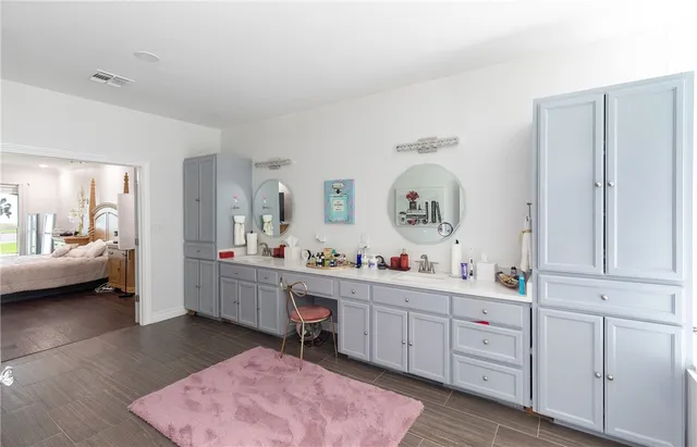 a view of a bedroom with workspace and mirror
