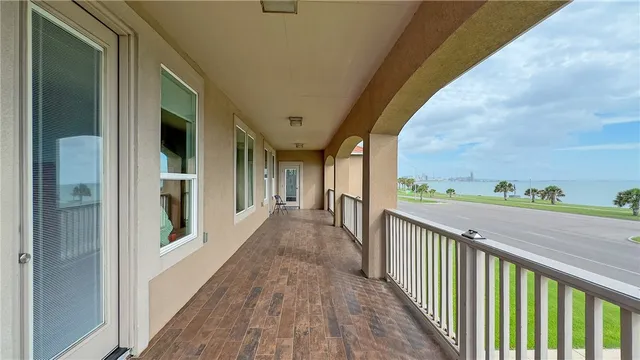 a view of a balcony with wooden floor