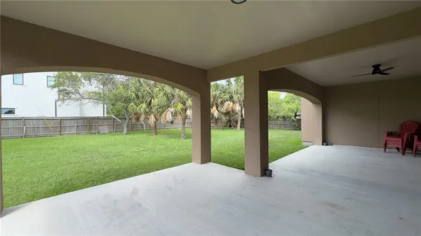 a view of a house with backyard and porch