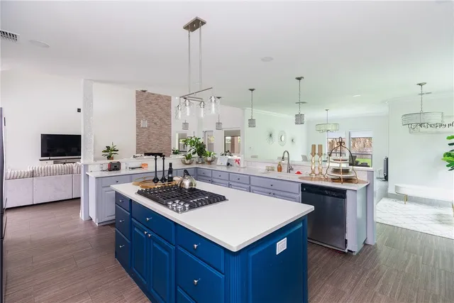 a kitchen with kitchen island a sink stove and wooden floor