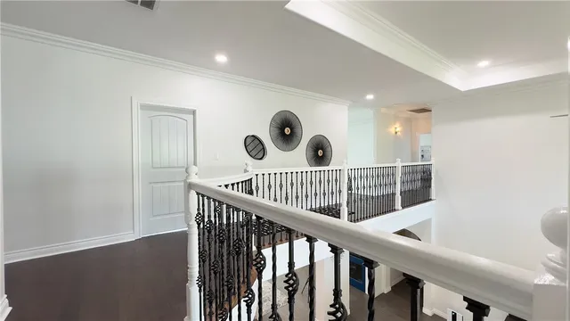 a view of a hallway with a large window and wooden floor