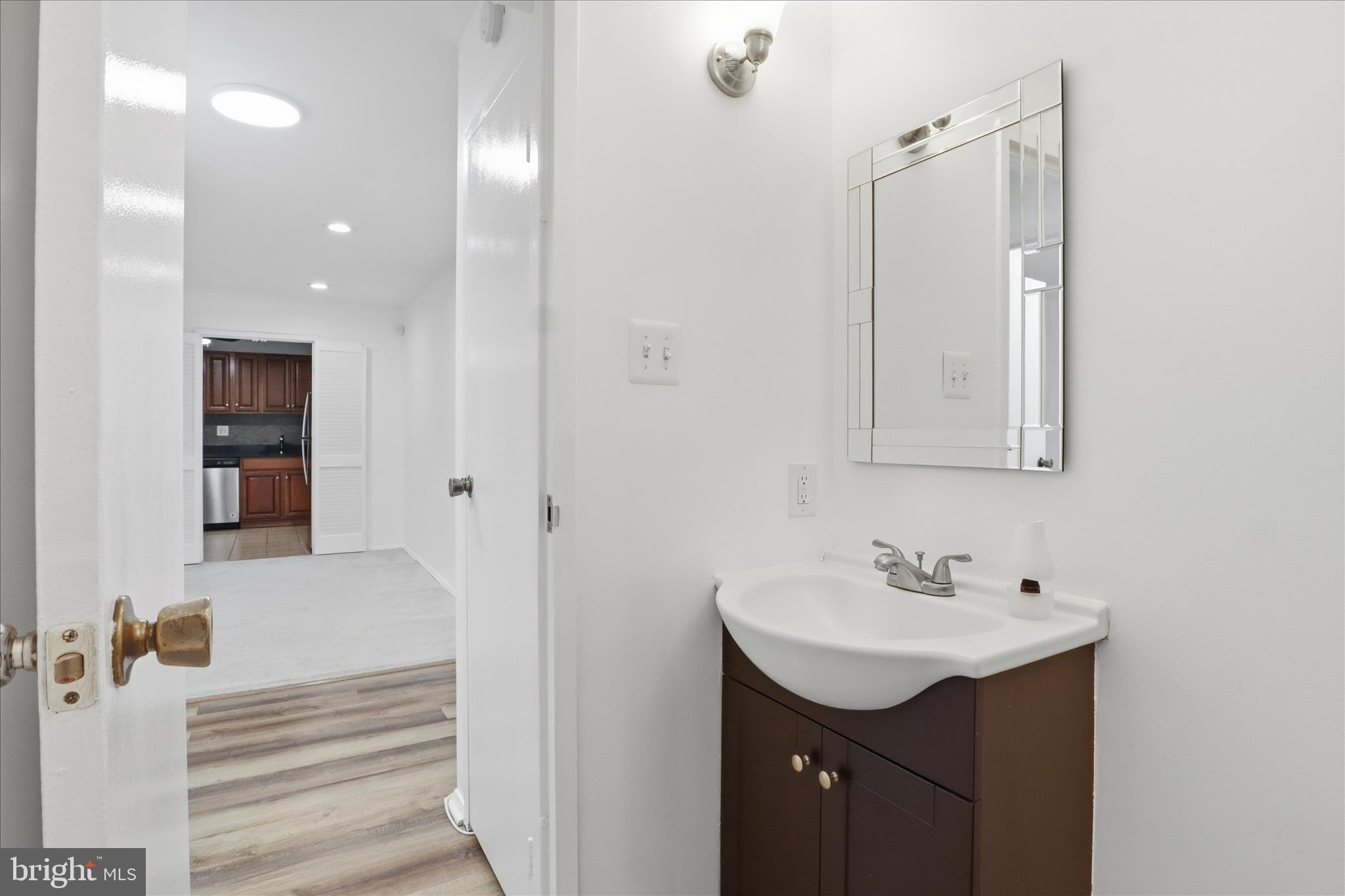 250 South Reynolds Street, Unit 105 Alexandria, VA 22304 - Photo 15 of 39 a bathroom with a sink vanity and a mirror