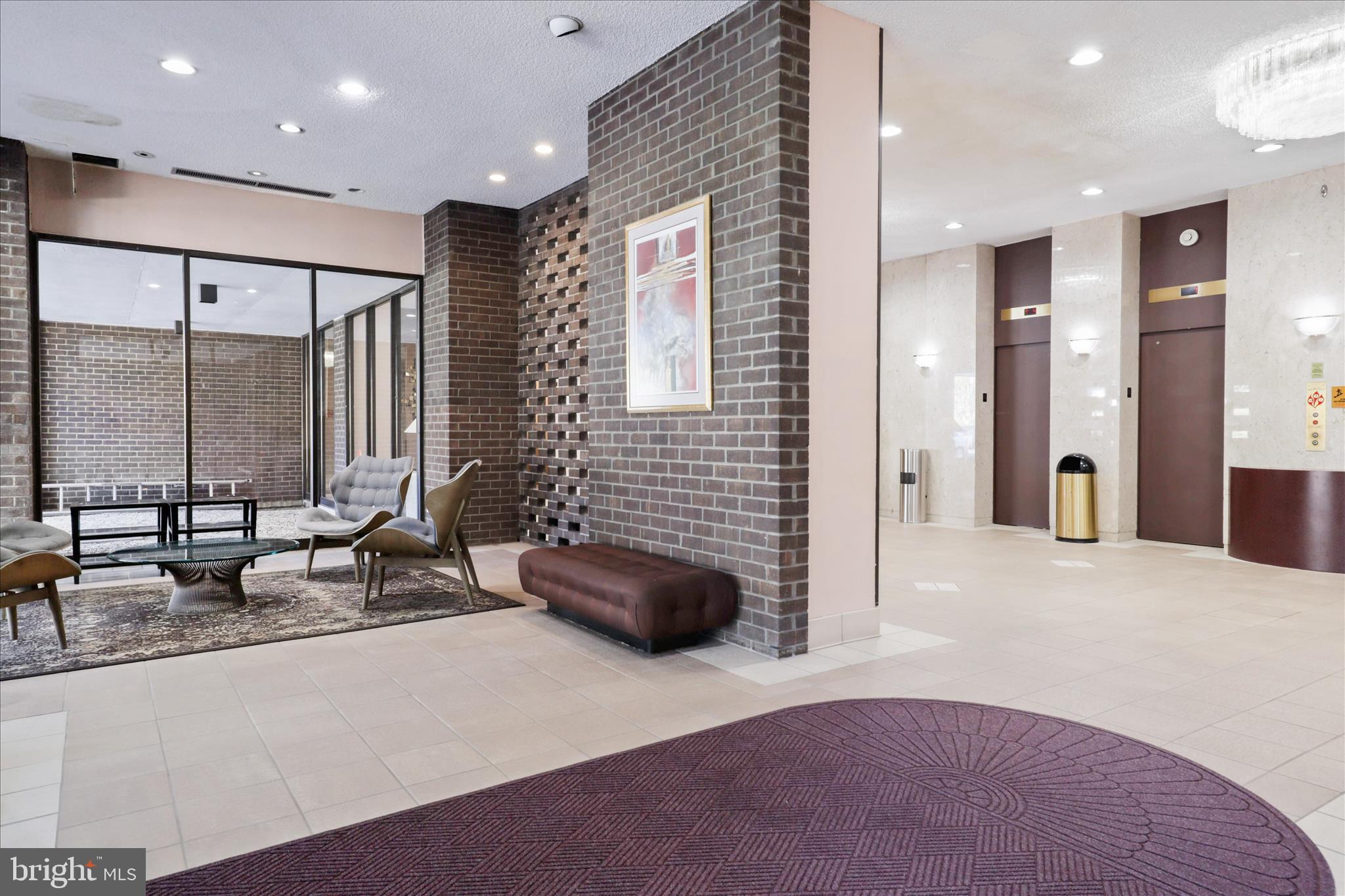 250 South Reynolds Street, Unit 105 Alexandria, VA 22304 - Photo 24 of 39 a lobby with a couch and a potted plant