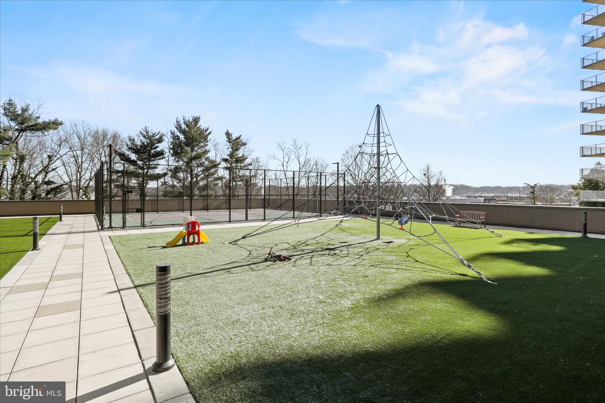 250 South Reynolds Street, Unit 105 Alexandria, VA 22304 - Photo 29 of 39 a view of outdoor space with swimming pool and trees in the background