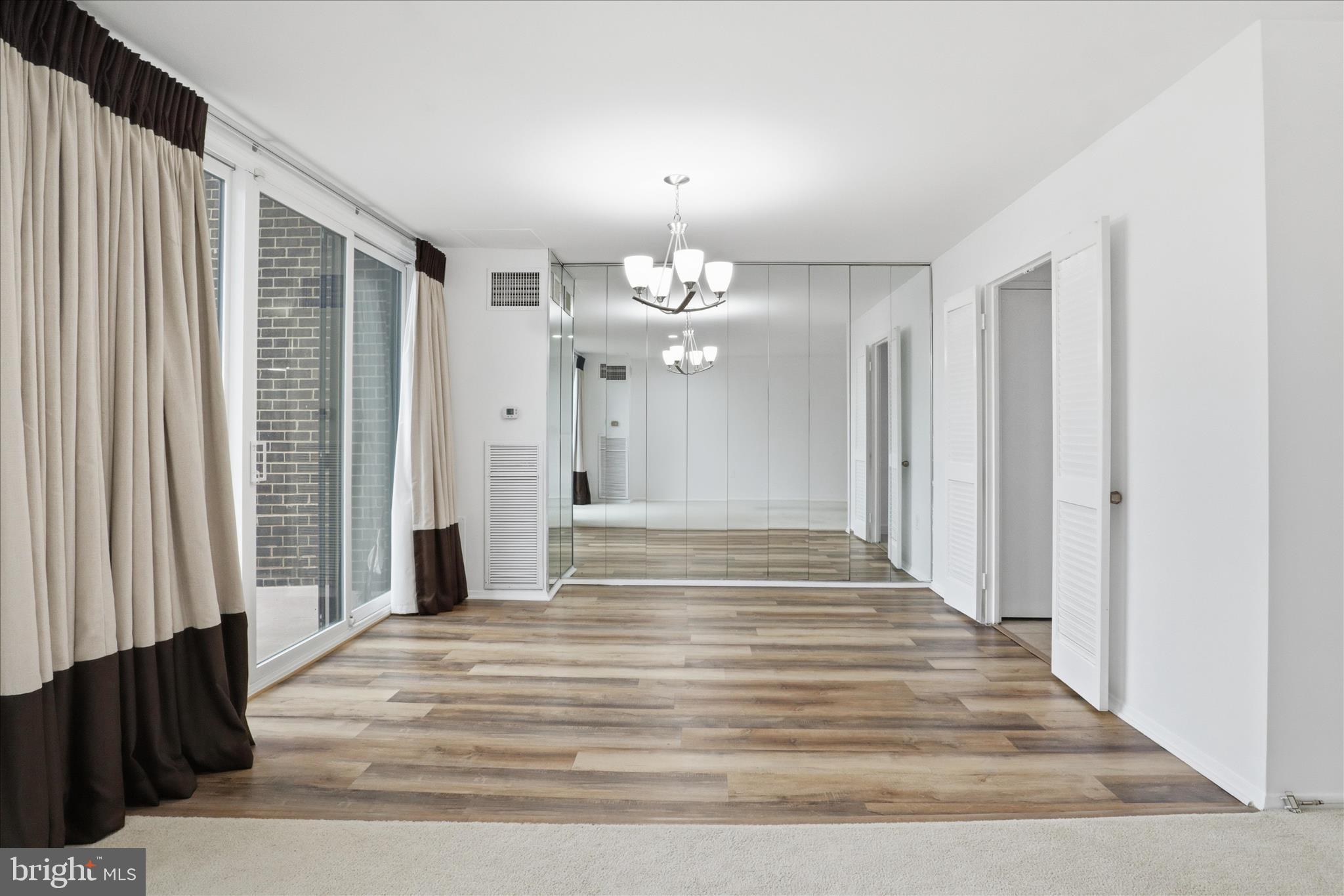 250 South Reynolds Street, Unit 105 Alexandria, VA 22304 - Photo 8 of 39 a view of a chandelier and wooden floor