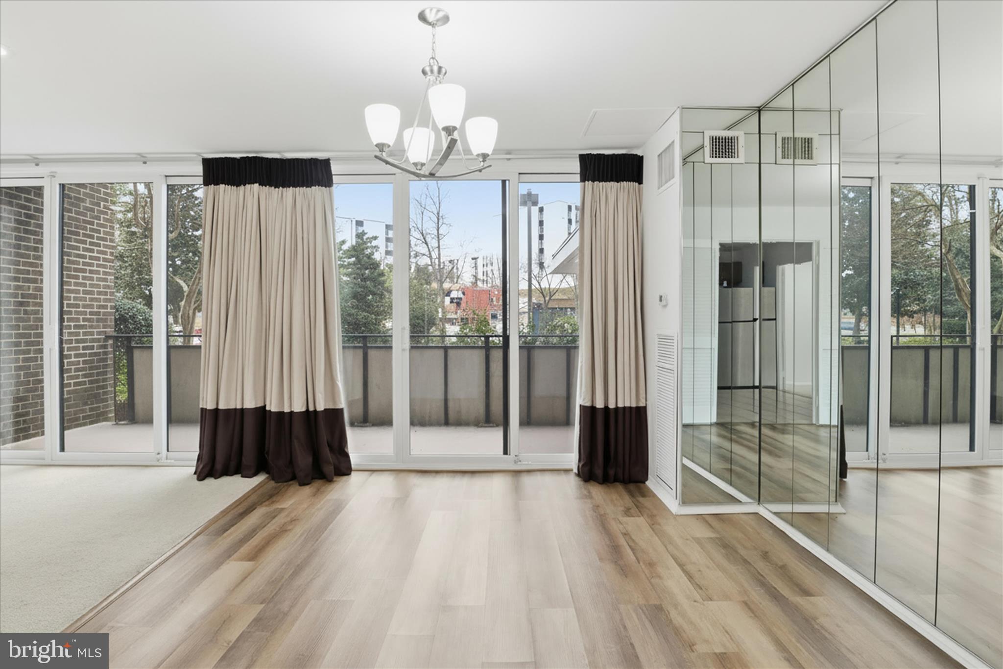 250 South Reynolds Street, Unit 105 Alexandria, VA 22304 - Photo 9 of 39 a view of a room with wooden floor and stairs