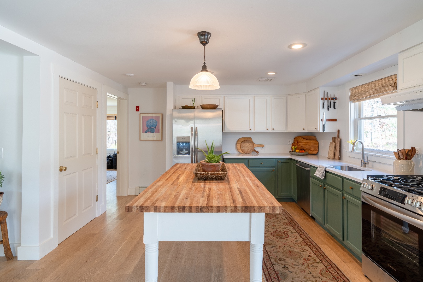 93 Hvoslef Way Vineyard Haven, MA 02568 - Photo 11 of 41 a kitchen with granite countertop a stove top oven a sink dishwasher and a stove with wooden floor