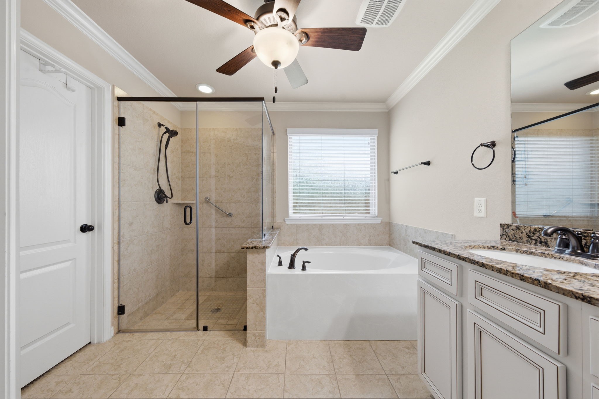 7611 Willow School Drive Spring, TX 77389 - Photo 14 of 23 a bathroom with a tub a sink and mirror