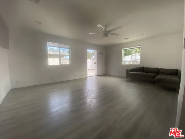 a view of a livingroom with furniture wooden floor and a window