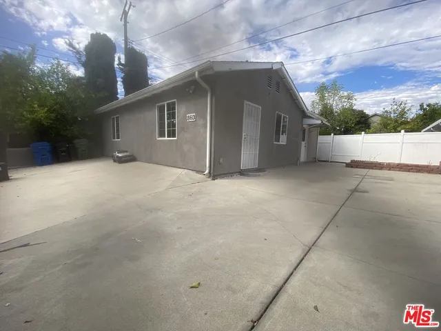 a view of a balcony with a floor to ceiling window and wooden fence