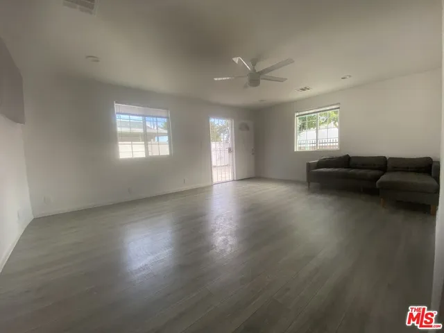 a view of livingroom with furniture wooden floor and windows
