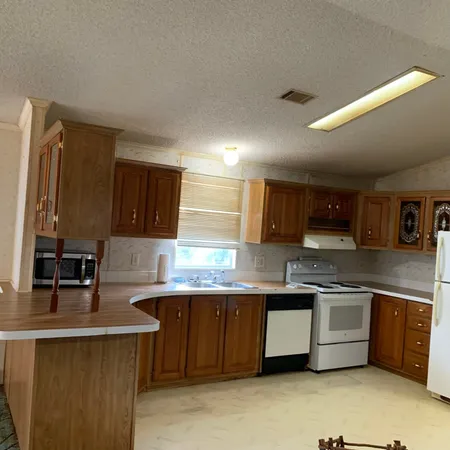 a kitchen with a sink a window and stainless steel appliances