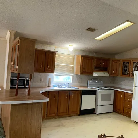 a kitchen with a sink a window and stainless steel appliances