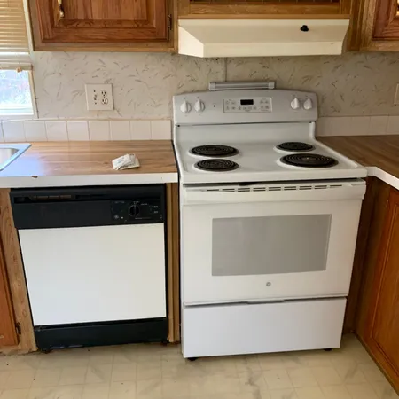 a kitchen with a refrigerator and a stove