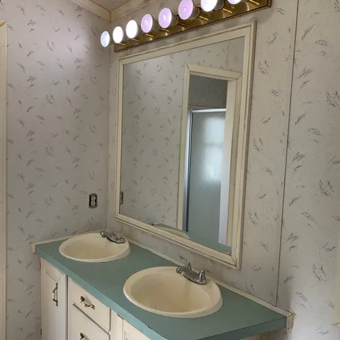 a bathroom with a tub a sink and a mirror