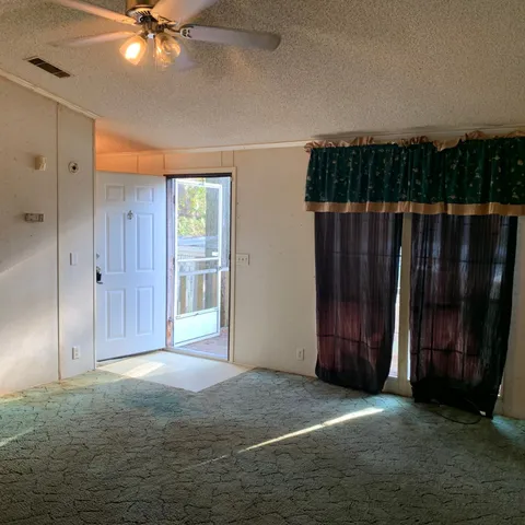 a kitchen with kitchen island granite countertop a sink a stove and refrigerator