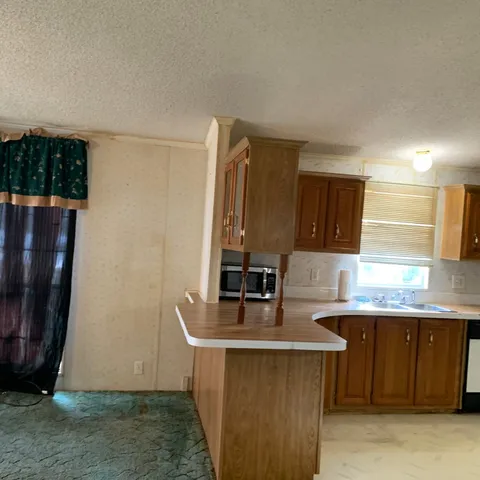 a view of a kitchen with wooden floor