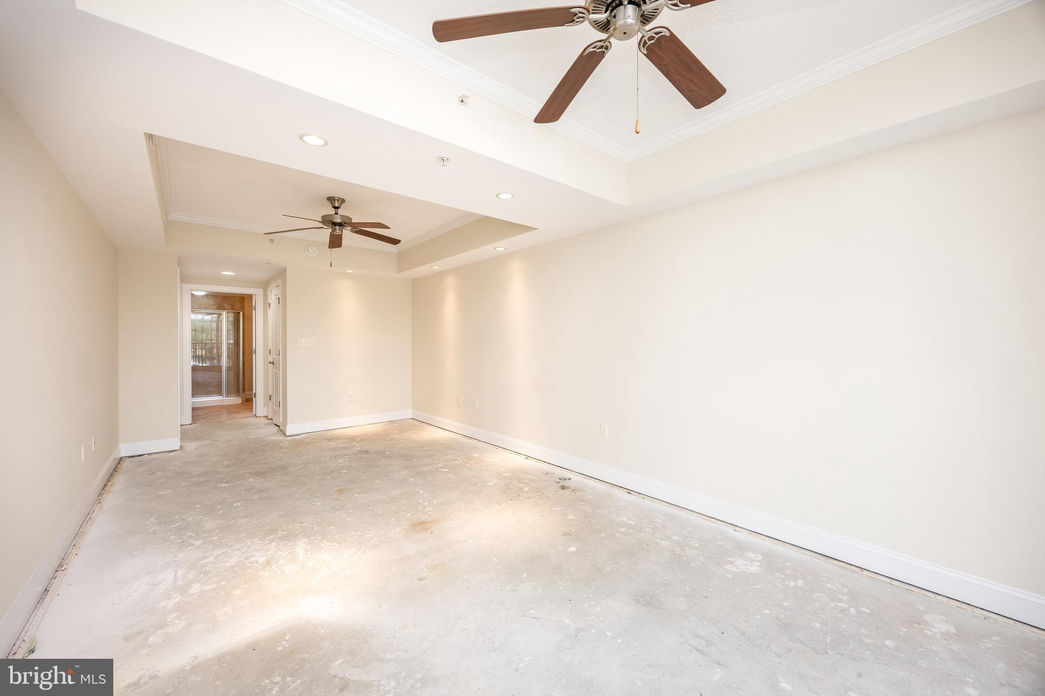 530 Riverside Drive, Unit 202 Salisbury, MD 21801 - Photo 15 of 61 an empty room with a ceiling fan and wooden floor