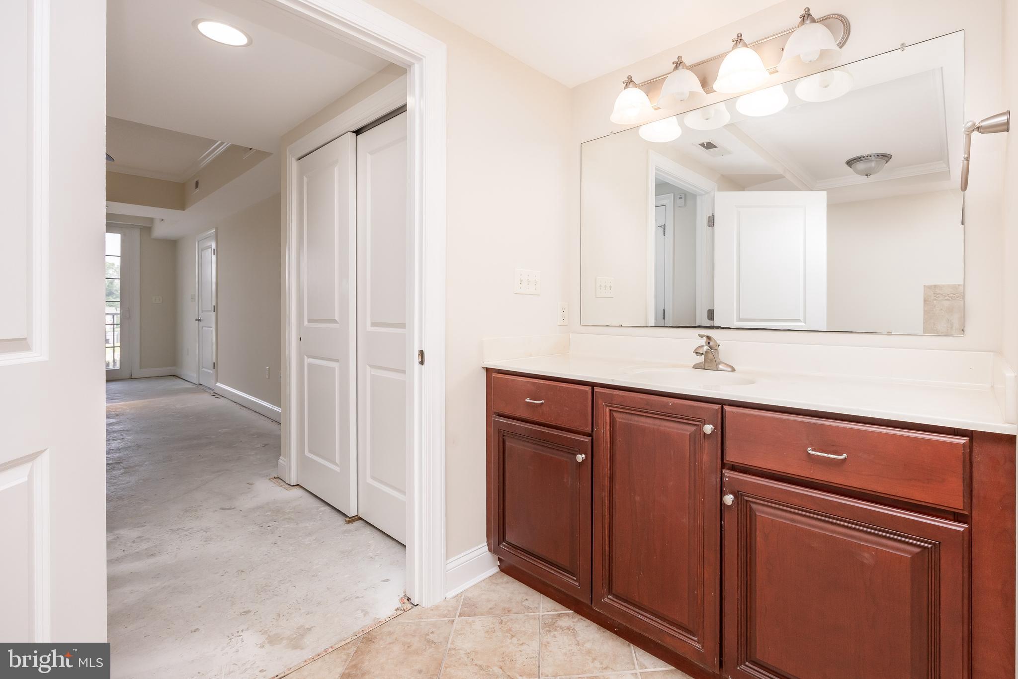 530 Riverside Drive, Unit 202 Salisbury, MD 21801 - Photo 22 of 61 a bathroom with a sink vanity and mirror