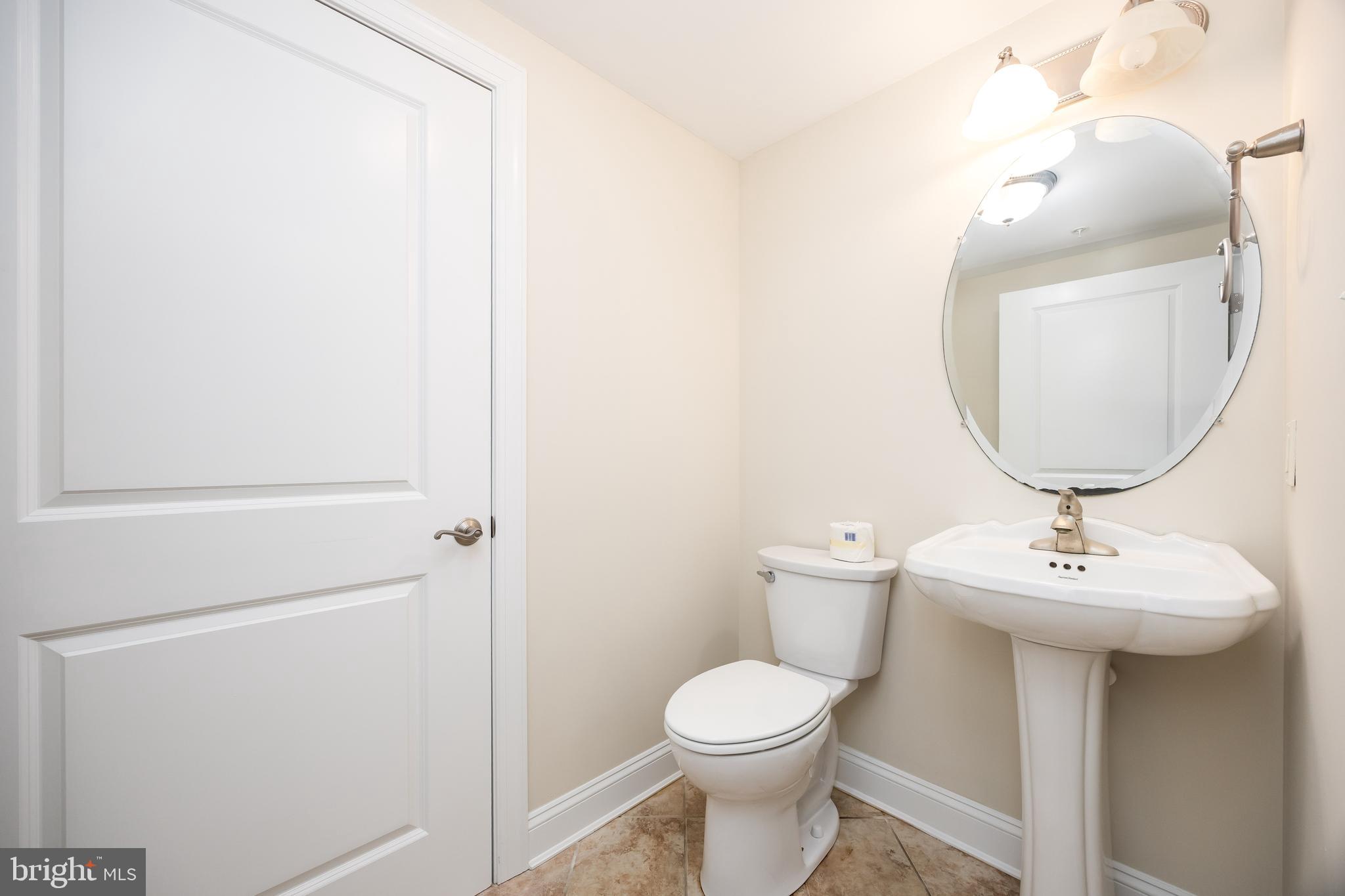 530 Riverside Drive, Unit 202 Salisbury, MD 21801 - Photo 24 of 61 a bathroom with a toilet sink and mirror