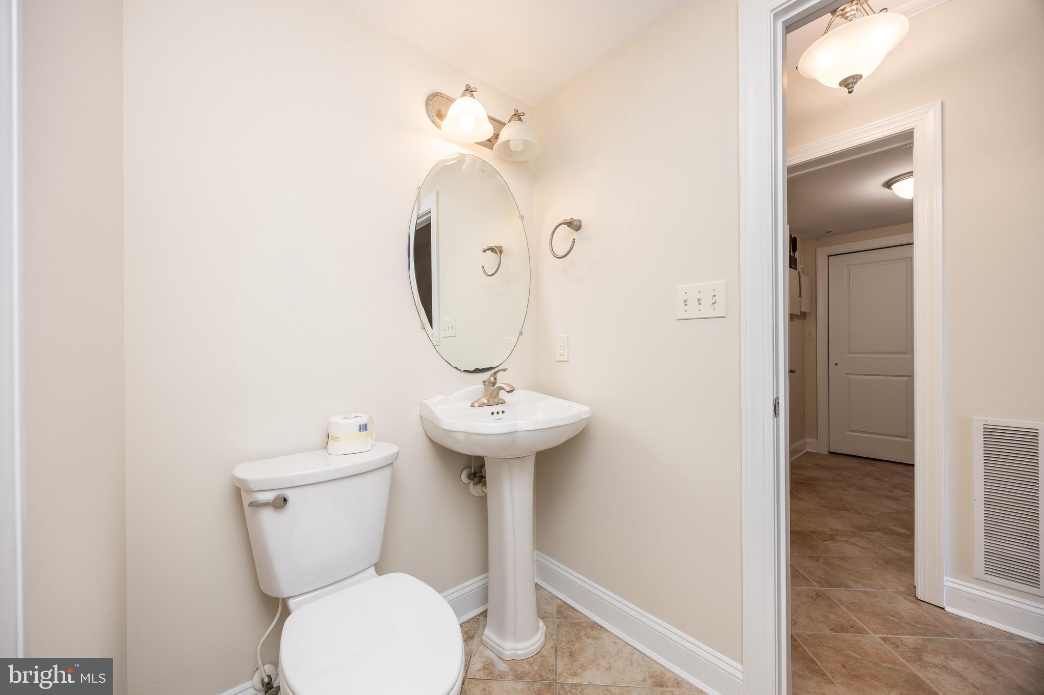 530 Riverside Drive, Unit 202 Salisbury, MD 21801 - Photo 26 of 61 a bathroom with a toilet sink and mirror
