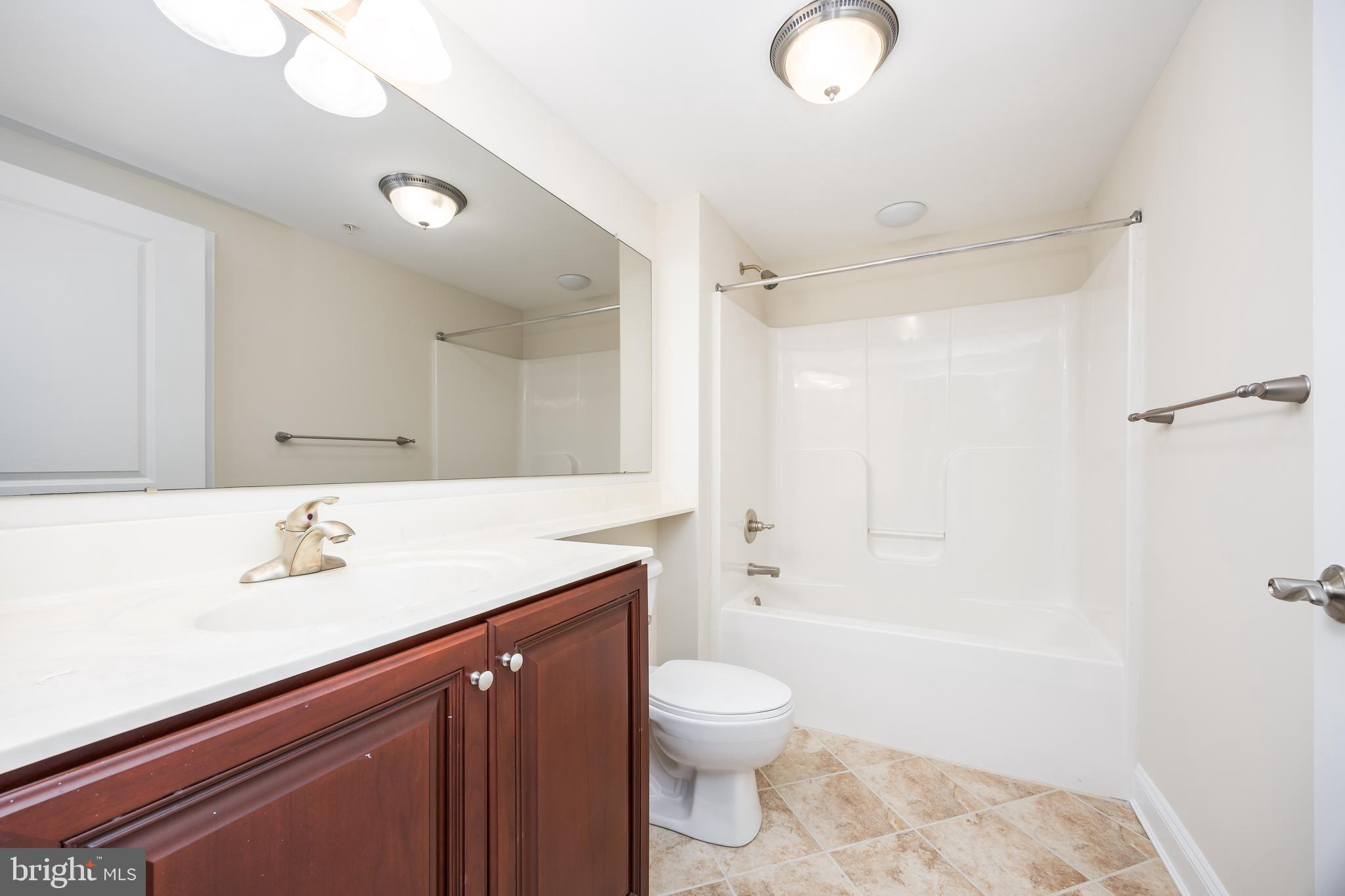 530 Riverside Drive, Unit 202 Salisbury, MD 21801 - Photo 27 of 61 a bathroom with a sink a toilet and shower