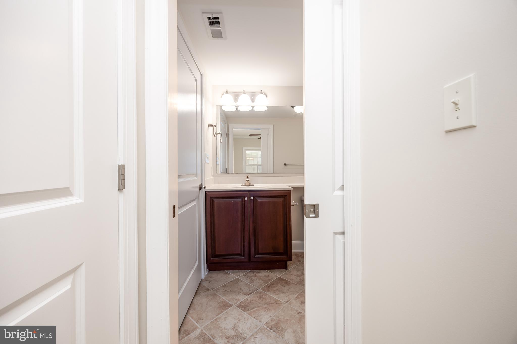 530 Riverside Drive, Unit 202 Salisbury, MD 21801 - Photo 30 of 61 a bathroom with a sink and a mirror