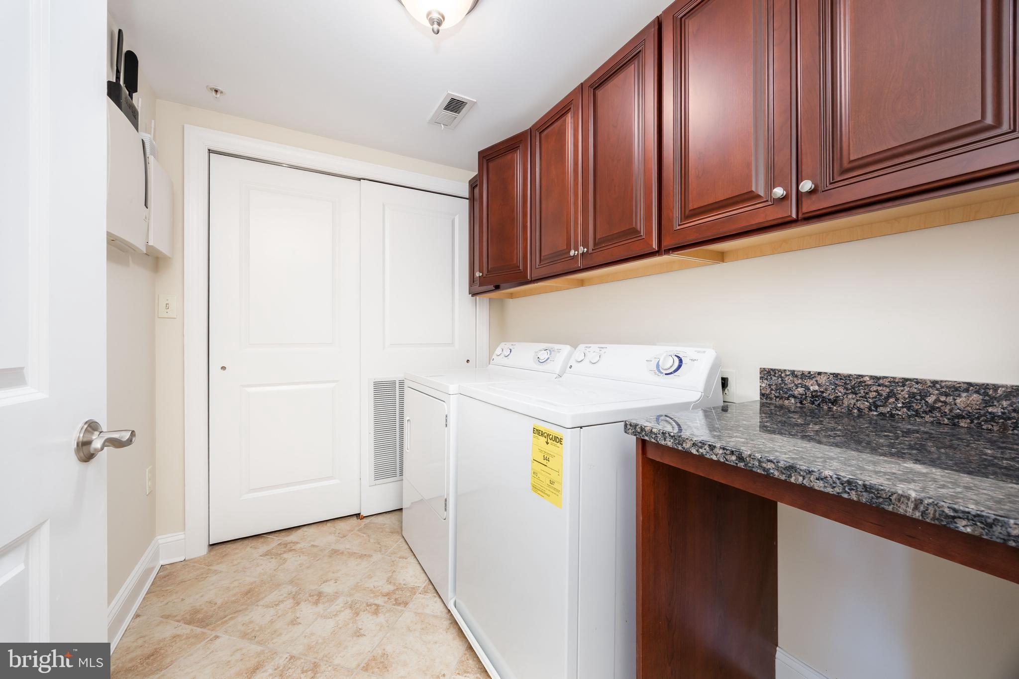 530 Riverside Drive, Unit 202 Salisbury, MD 21801 - Photo 37 of 61 a utility room with granite countertop cabinets washer and dryer