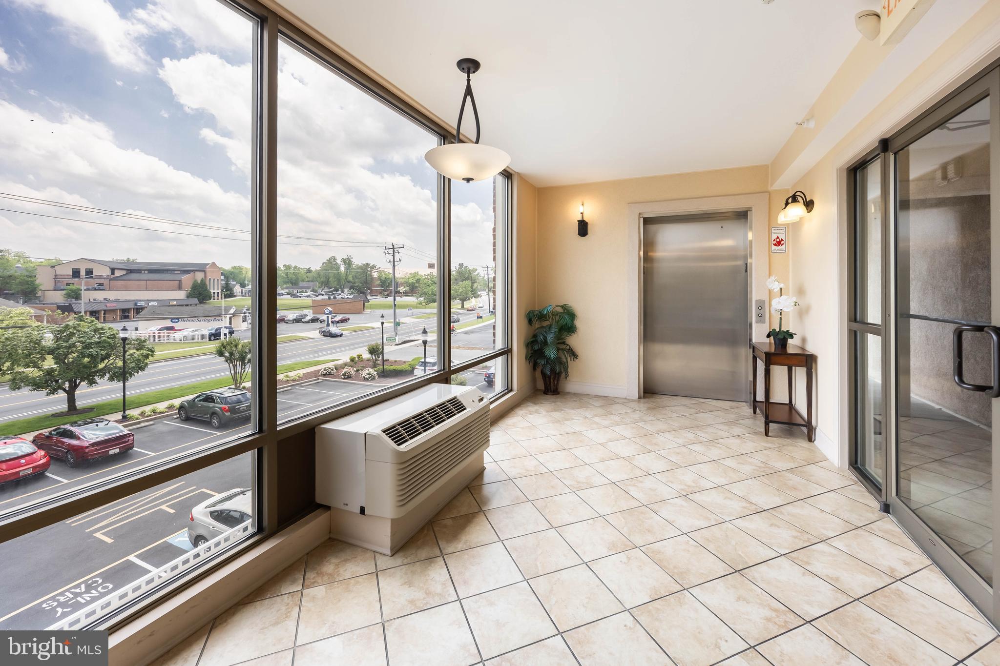 530 Riverside Drive, Unit 202 Salisbury, MD 21801 - Photo 49 of 61 a living room with a large window and table