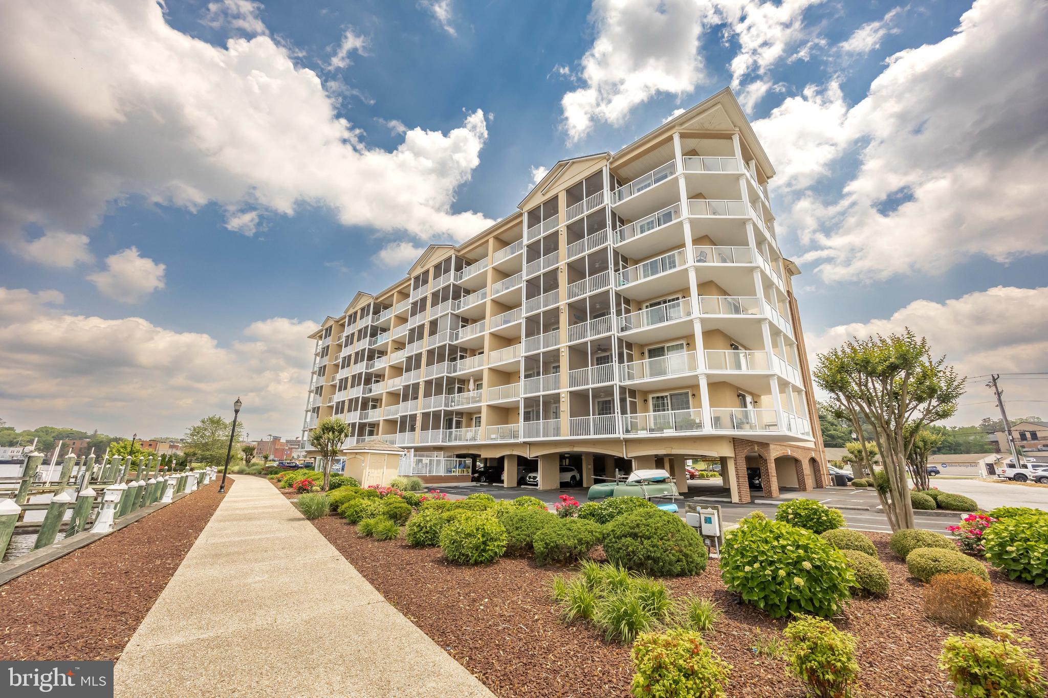 530 Riverside Drive, Unit 202 Salisbury, MD 21801 - Photo 51 of 61 a view of a tall building with a yard