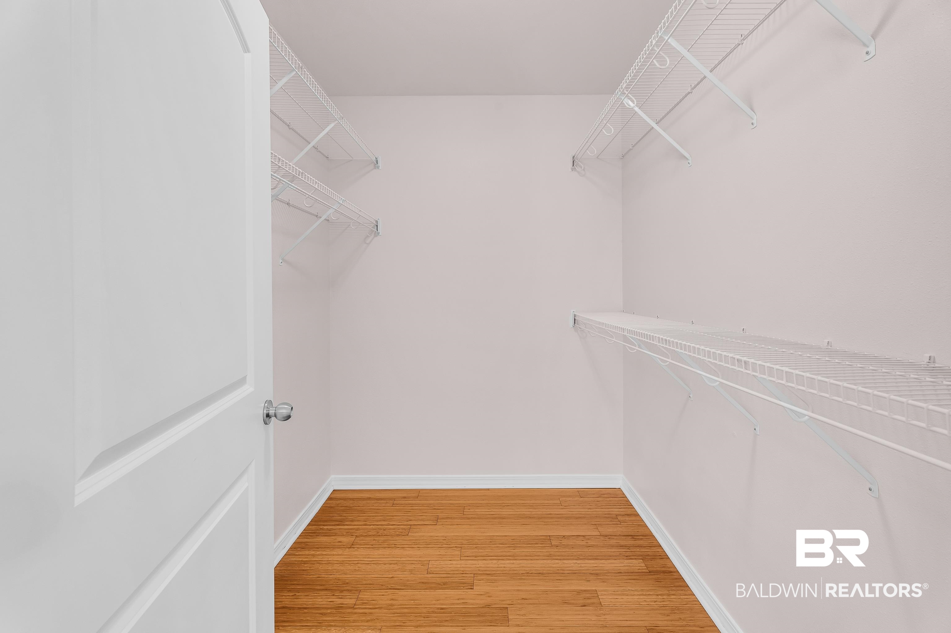 22095 8th Street Silverhill, AL 36576 - Photo 31 of 42 Walk in closet with light wood finished floors