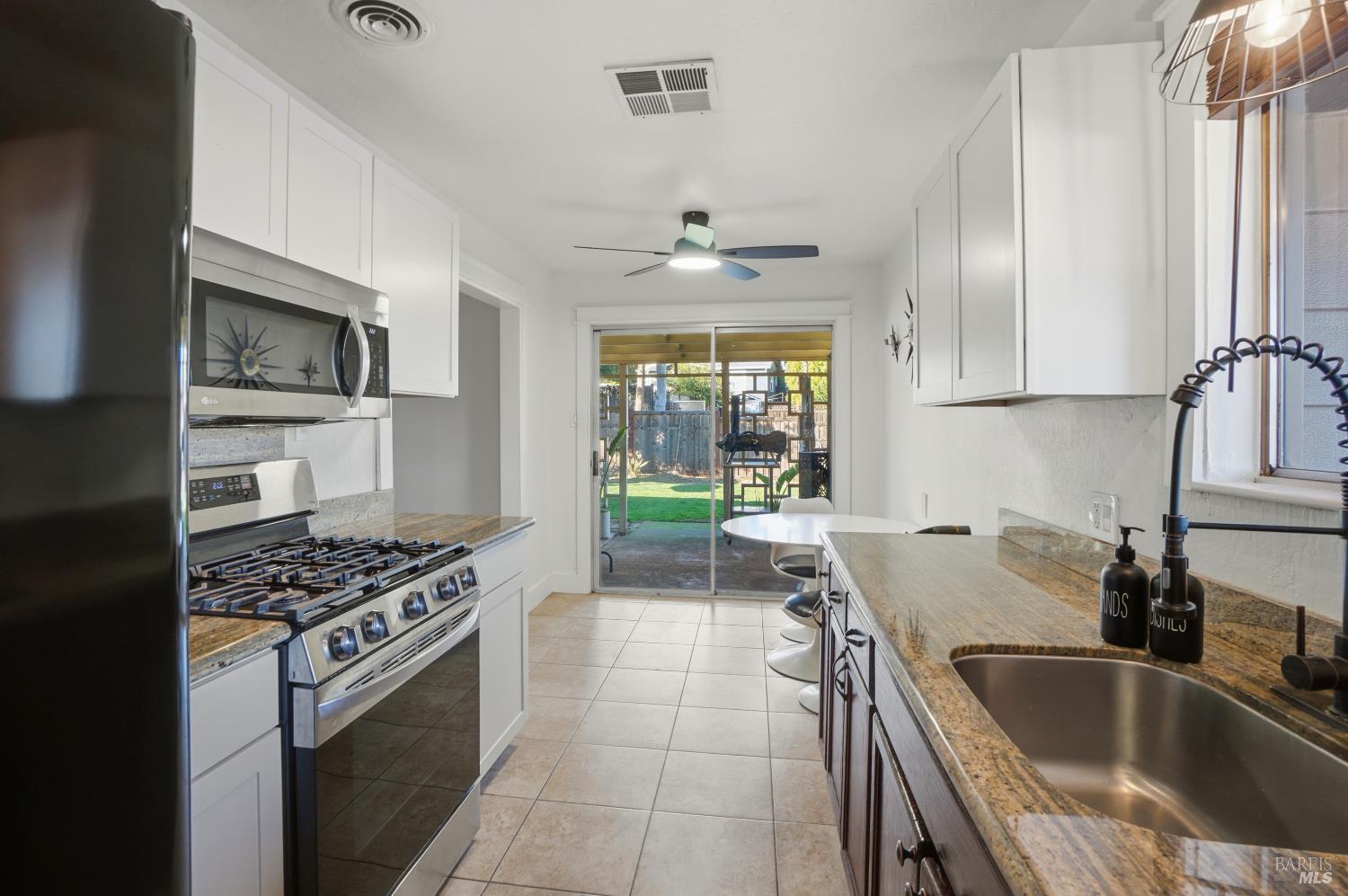 823 Shell Avenue Martinez, CA 94553 - Photo 13 of 39 a kitchen with kitchen island stainless steel appliances a sink stove and cabinets