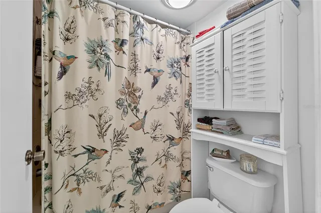 a bathroom with a toilet a sink and a mirror