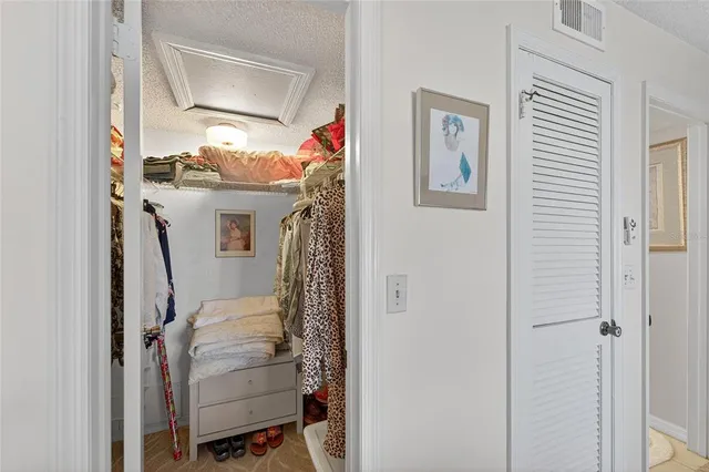 a bedroom with two beds and a lamp