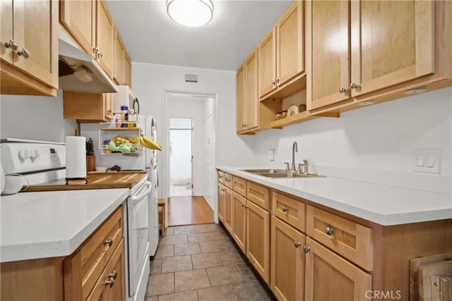 a kitchen with stainless steel appliances granite countertop a sink a stove and cabinets