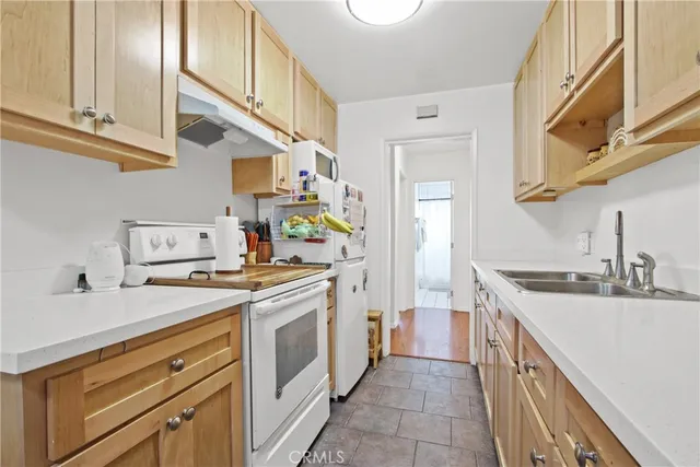 a kitchen with a sink stove and cabinets