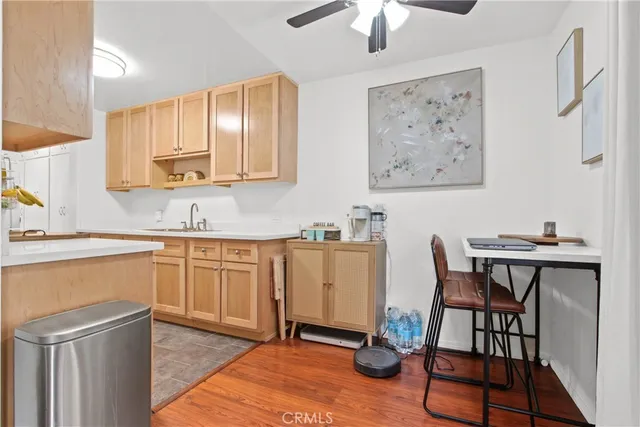 a kitchen with stainless steel appliances granite countertop a stove a sink dishwasher and cabinets with wooden floor