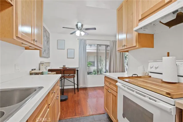 a kitchen with a stove a sink and a refrigerator