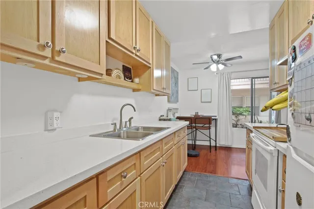 a kitchen with stainless steel appliances granite countertop a sink and cabinets