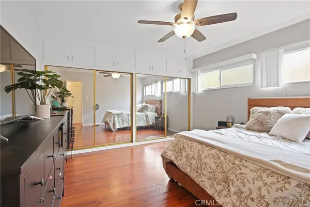 a spacious bedroom with a bed and a chandelier