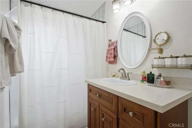 a bathroom with a sink vanity and a mirror