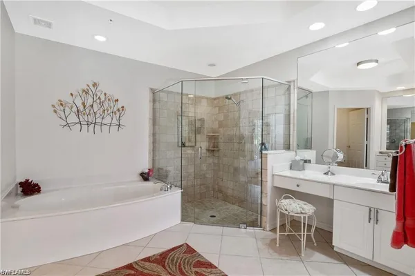 a bathroom with a bathtub shower sink and a mirror